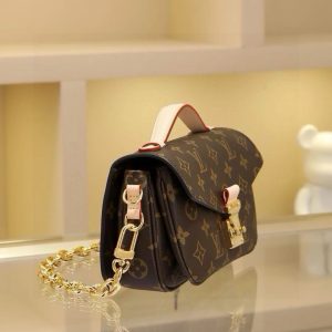 Alternative view of The East West Métis handbag features a stylish shoulder bag silhouette with a trendy aesthetic. Crafted from the brand's Monogram canvas, this compact piece boasts a distinctive S-lock clasp and a chic top handle, with a polished surface that gleams brilliantly. Versatile and spacious, it includes a detachable long shoulder strap for comfortable crossbody or shoulder carry. An ideal companion for everyday outings. Dimensions: 21.5 x 6 x 13.5 cm